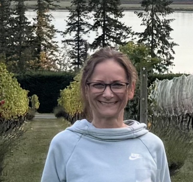 Heidi, owner and instructor at SLOW burn Pilates, smiling outdoors